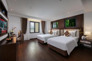 Voodi või voodid majutusasutuse The Q Hotel toas