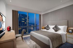 a hotel room with a bed and a large window at Ascott Raffles City Chongqing in Chongqing