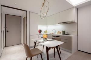 a kitchen with a table and chairs in a kitchen at Ascott Raffles City Chongqing in Chongqing