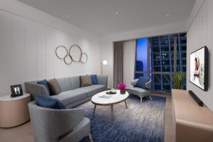 a living room with a couch and a table at Ascott Raffles City Chongqing in Chongqing