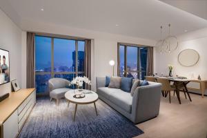 a living room with a couch and a table at Ascott Raffles City Chongqing in Chongqing