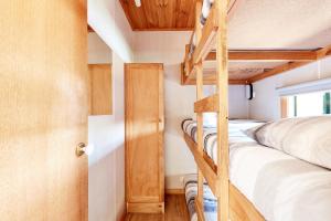 a bedroom with two bunk beds and a ladder at Torquay Foreshore Caravan Park in Torquay
