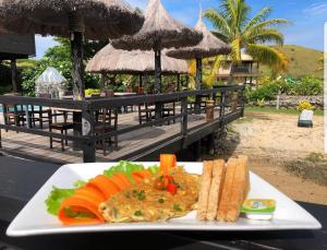 a plate of food on a table at a resort at Golden Point Resort in Rakiraki