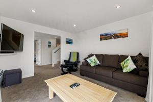a living room with a couch and a coffee table at Queenstown Lake Views - Downstairs Apartment in Queenstown