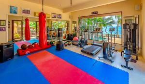 a fitness room with a gym with a red and blue carpet at Sibaja Palms Sunset Beach Luxury Apartments in Taling Ngam Beach