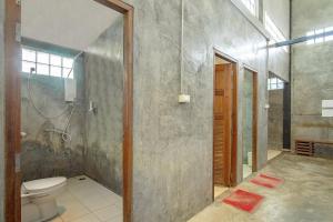 a bathroom with a toilet and a shower at OYO 585 Freedom Hostel @ Phi Phi in Phi Phi Islands