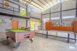 a room with a pool table and some chairs at OYO 585 Freedom Hostel @ Phi Phi in Phi Phi Islands