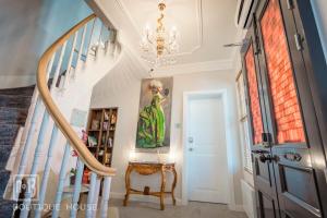 a staircase in a home with a painting on the wall at No13 Boutique House in Burgas
