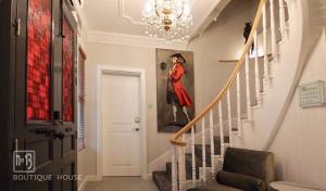 a hallway with a painting of a man on the wall at No13 Boutique House in Burgas City