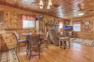 a dining room with a table and chairs in a cabin at Bear Den in Sevierville