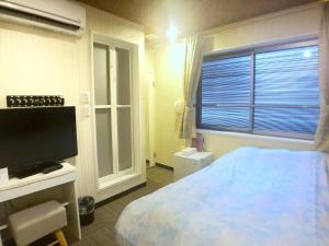 Postel nebo postele na pokoji v ubytování Tokyo Tourist Inn