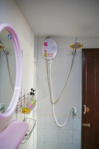 a shower in a bathroom with a blow dryer on the wall at Laemson Resort in Srithanu +49 photos