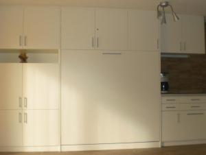 a kitchen with white cabinets and a refrigerator at Ferienwohnungen Wagner am Brombachsee in Pleinfeld