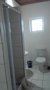 a bathroom with a toilet and a window at Guest Lodge on the Edge in Stormsrivier