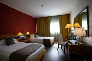 Säng eller sängar i ett rum på BV Hotel Oly