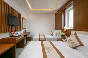 Postel nebo postele na pokoji v ubytování Prague Da Nang Beach Hotel