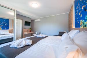 a bedroom with a large bed with white sheets at San Mar Lopar in Lopar