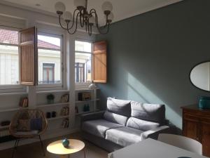 a living room with a couch and two windows at L'Esplai Valencia in Valencia