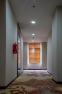 an empty hallway with a window with a window blind at Hotel Sanchaung in Yangon