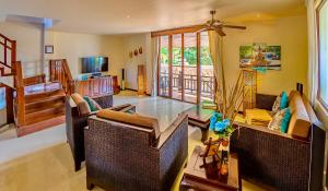 a living room with a table and chairs at Sibaja Palms Sunset Beach Luxury Villa in Taling Ngam Beach