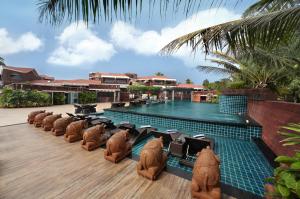 a row of brown bears sitting in front of a pool at Mayfair Heritage in Puri