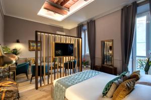 a living room with a large bed and a television at Tree Charme Parliament Boutique Hotel in Rome