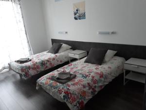 two beds sitting next to each other in a room at Gite Izaxulo in Saint-Jean-Pied-de-Port