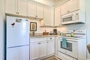 a kitchen with white cabinets and a white refrigerator at Harbor Oaks Haven Walk to Front Beach and Downtown! in Ocean Springs +26 photos
