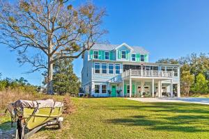 a large blue house with a yellow boat in front of it at Harbor Oaks Haven Walk to Front Beach and Downtown! in Ocean Springs