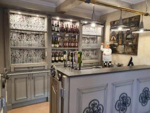 a bar with a bartender standing behind the counter at La-Perna Guesthouse and Venue in Pretoria