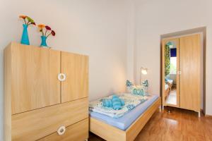 1 dormitorio con 1 cama y armario de madera en Ferienwohnung Park, en Erfurt