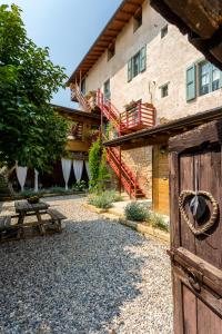 a barn with a wooden door and a building at Agriturismo Conte Brunello in Salò