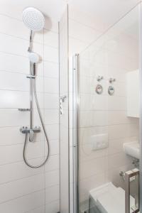 a bathroom with a shower with a glass door at Ferienwohnung City in Erfurt +15 photos