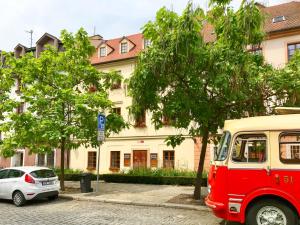 a red van parked in front of a building at Golden Wood Apartments in Plzeň