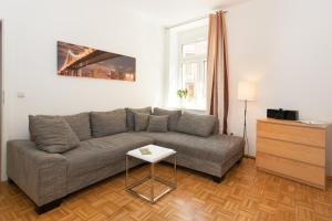 a living room with a couch and a table at Ferienwohnung Petersberg in Erfurt