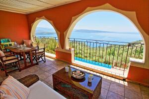 a living room with a view of the ocean at Villa Vilelmina in Agnítsini