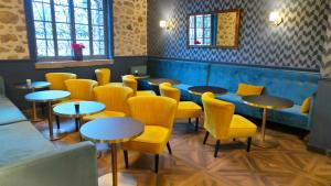 a row of tables and yellow chairs in a restaurant at Hotel Relais Du Postillon in Antibes
