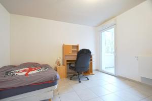 a bedroom with a bed and a desk and a chair at Beautiful Bright Apt With Terrace in Lyon +6 photos