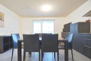 a kitchen with a dining room table and chairs at Beautiful Bright Apt With Terrace in Lyon