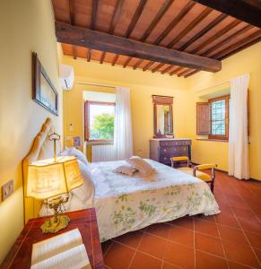 a bedroom with a bed and a table with a lamp at Portion of Villa with Private pool in Vaglia