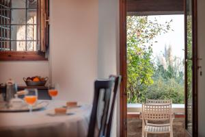 a dining room with a table and a window at Portion of Villa with Private pool in Vaglia