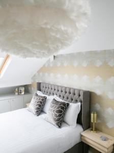 1 dormitorio con 1 cama blanca grande con almohadas en Sanderson Suites en Harrogate