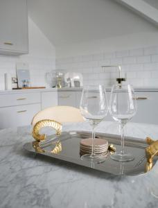 two wine glasses and a tray on a kitchen counter at Sanderson Suites in Harrogate