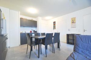 a kitchen and dining room with a table and chairs at Beautiful Bright Apt With Terrace in Lyon