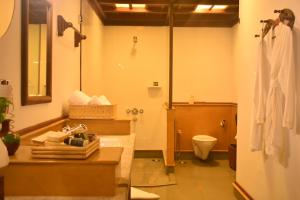 a bathroom with a toilet a sink and a shower at Kumarakom Lake Resort in Kumarakom