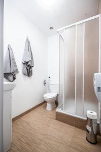 a bathroom with a toilet and a glass shower at Apartment in the center of Warsaw in Warsaw