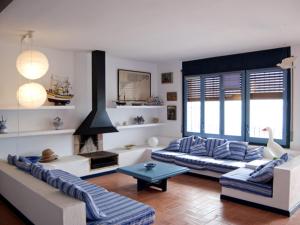 a living room with two couches and a fireplace at AT303 Botigues de Mar in Altafulla