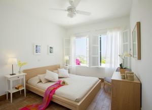 a white bedroom with a bed and a window at Ayios Elias Pearl in Protaras +69 photos
