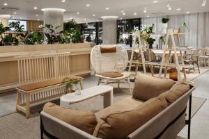 a store with a couch and chairs in a store at Original Sokos Hotel Tripla Helsinki in Helsinki +21 photos