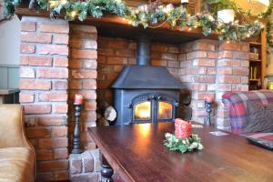 a fire place in a brick building with a fireplace at Halfway House in Great Malvern